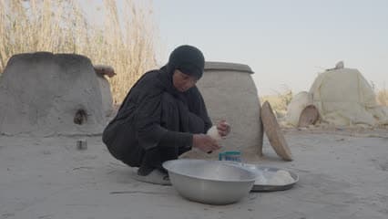 A woman preparing Iraqi bread, the dough